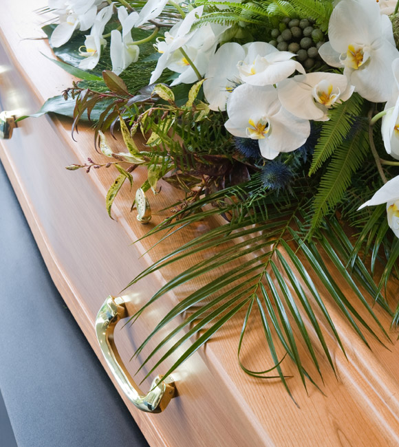 casket with white flower on top